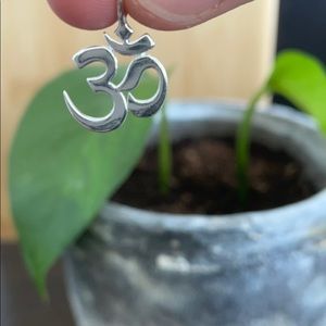 Stamped 925 sterling silver om necklace charm.